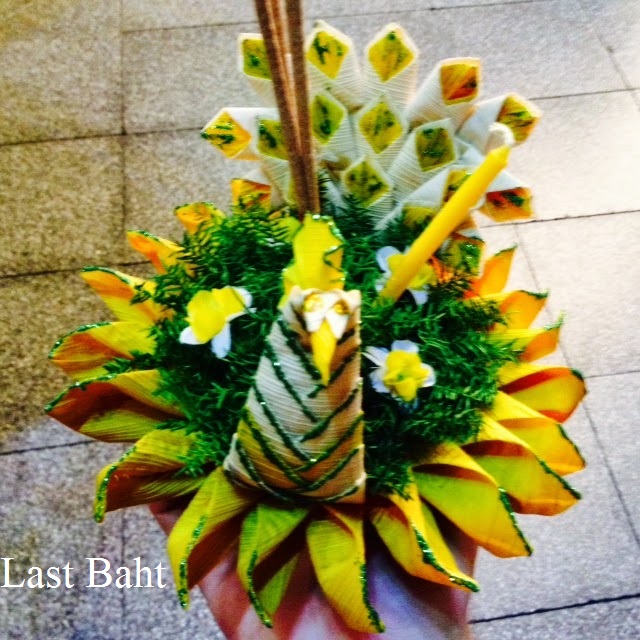 a green and yellow krathong float for a Thai river festival