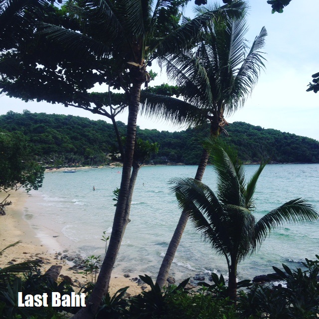 a quiet and beautiful beach with palm trees and blue water on Koh Samet Island, Thailand