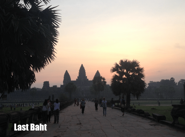 the sun rises over Angkor Wat temple historical park in Siem, Reap Cambodia against a pink and purple sky