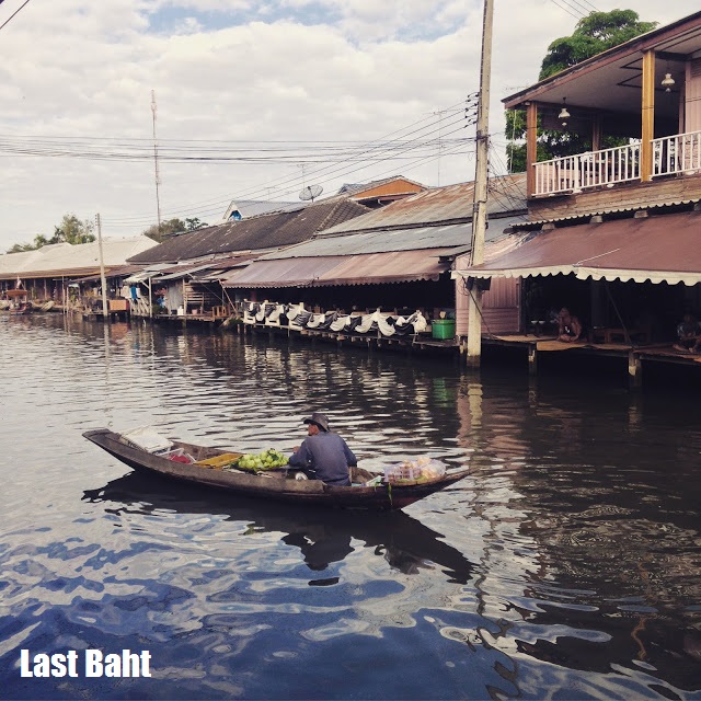 amphawa floating market vendor on boat in early morning